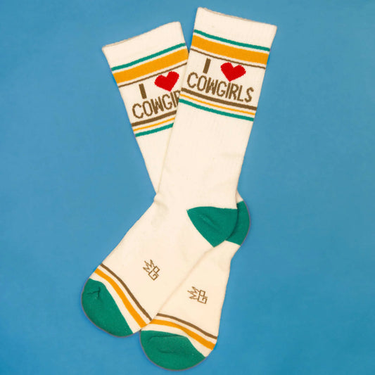 Cowgirl-loving crew socks with a red heart and retro stripe design, reading "I ❤️ Cowgirls," displayed on a bright blue background.