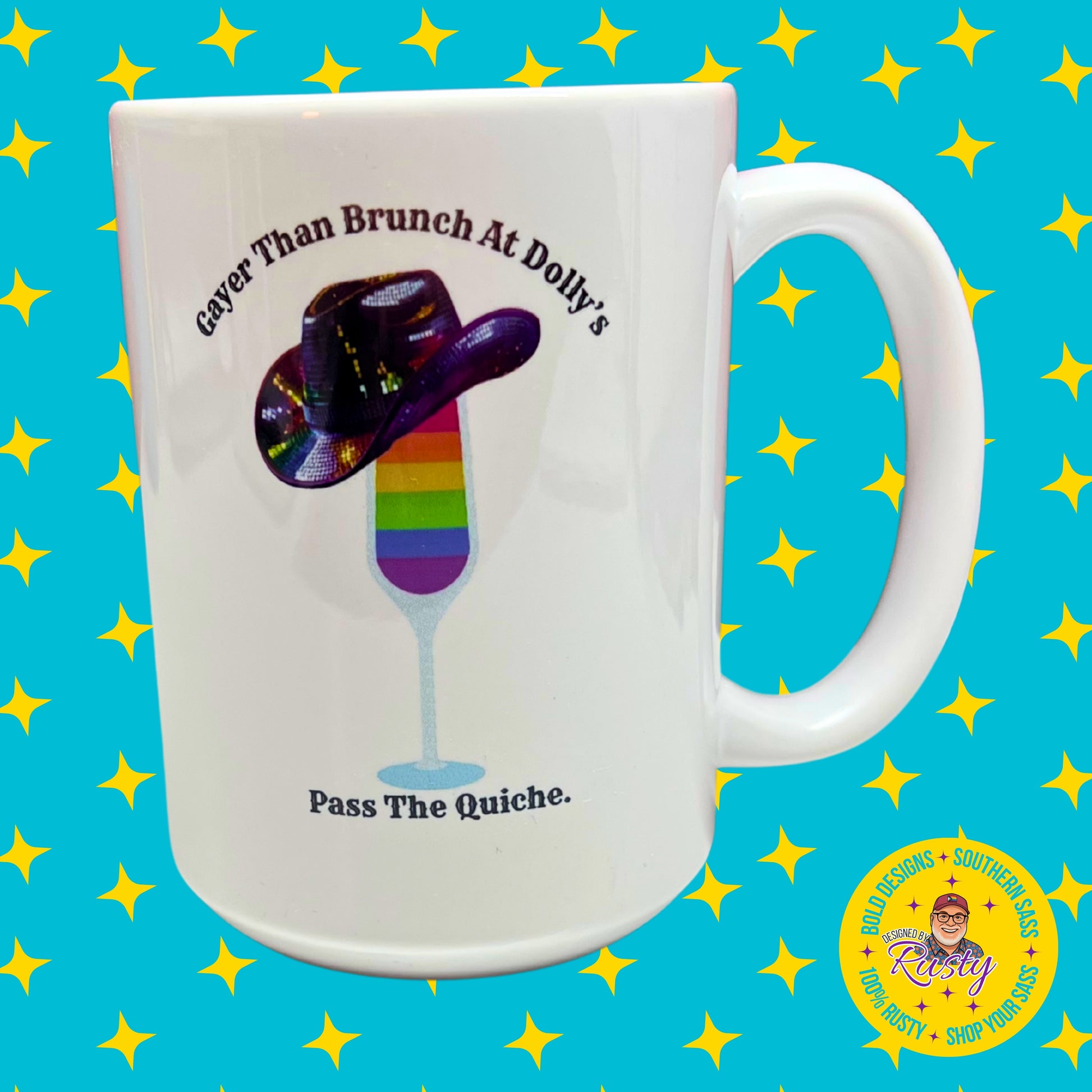 White 15 oz ceramic mug with rainbow mimosa and sequin cowboy hat design, on turquoise background with yellow stars and Designed by Rusty logo.
