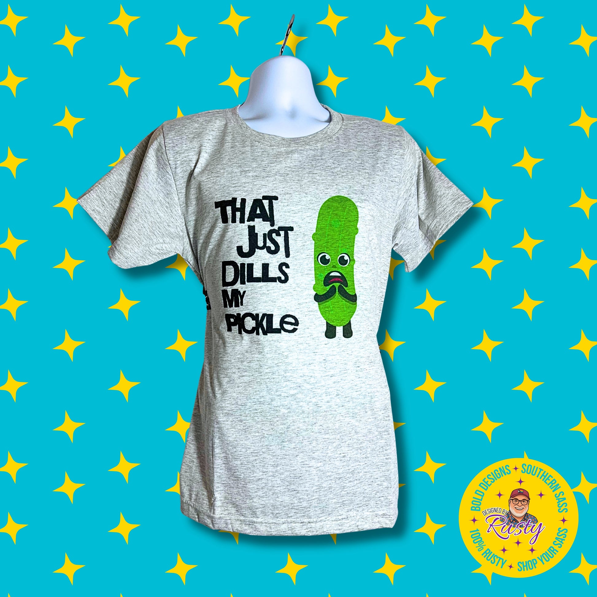 Light gray unisex t-shirt with “That Just Dills My Pickle” text and cartoon pickle, on turquoise DBR star background with logo.