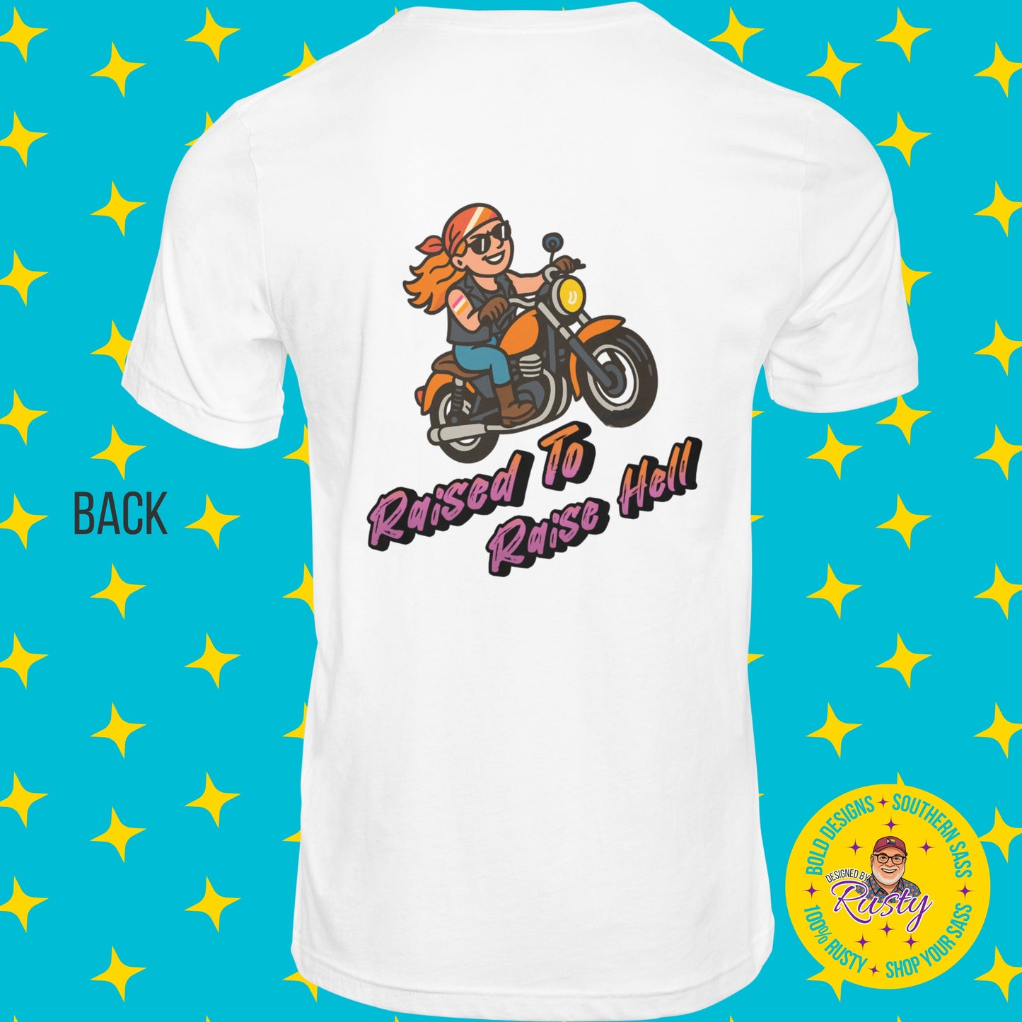 White women’s T-shirt with cartoon biker woman and “Raised to Raise Hell” design on the back, shown on turquoise star background with Designed by Rusty logo.