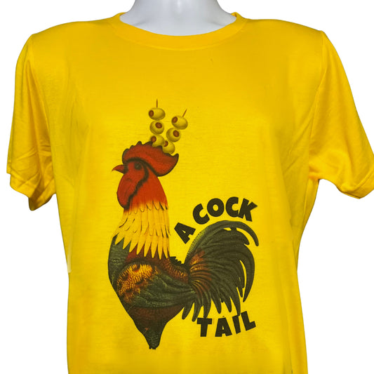 Yellow T-shirt with black rooster illustration wearing olives on toothpicks as a headpiece and the word Cocktail, displayed against white background.