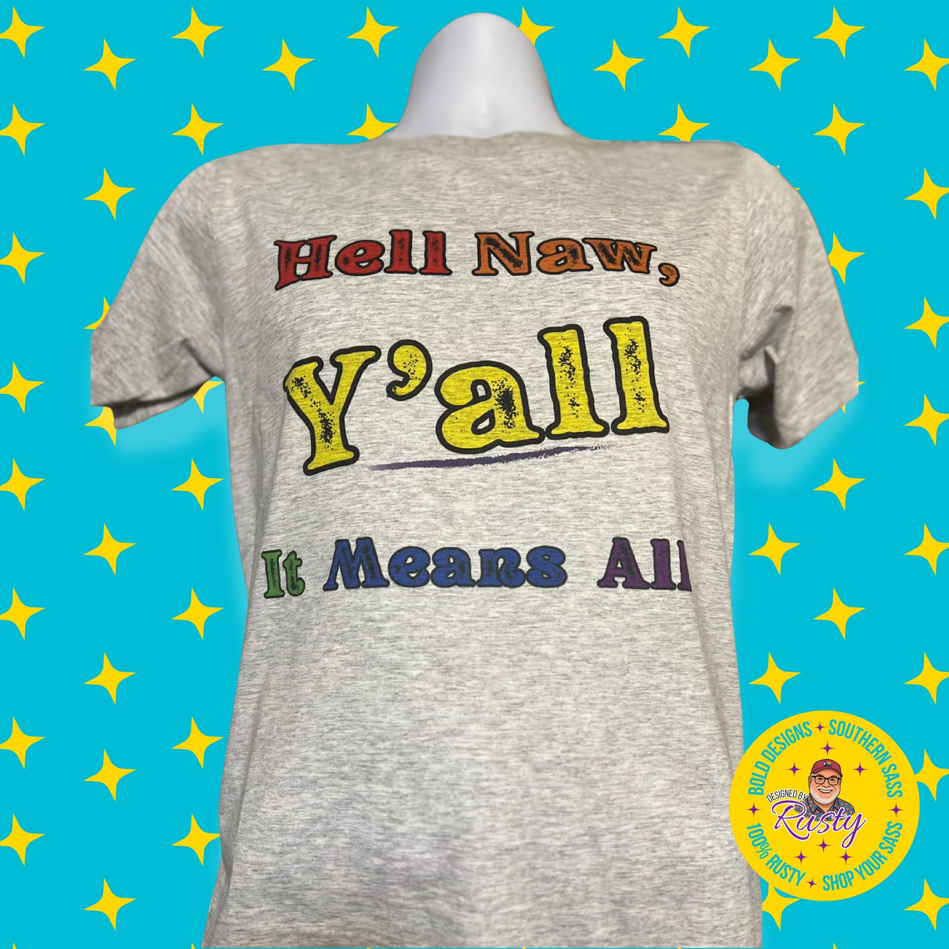 Gray t-shirt with colorful text, Hell Naw, Y'all It Means All on a blue background with yellow stars, including the Designed by Rusty logo.
