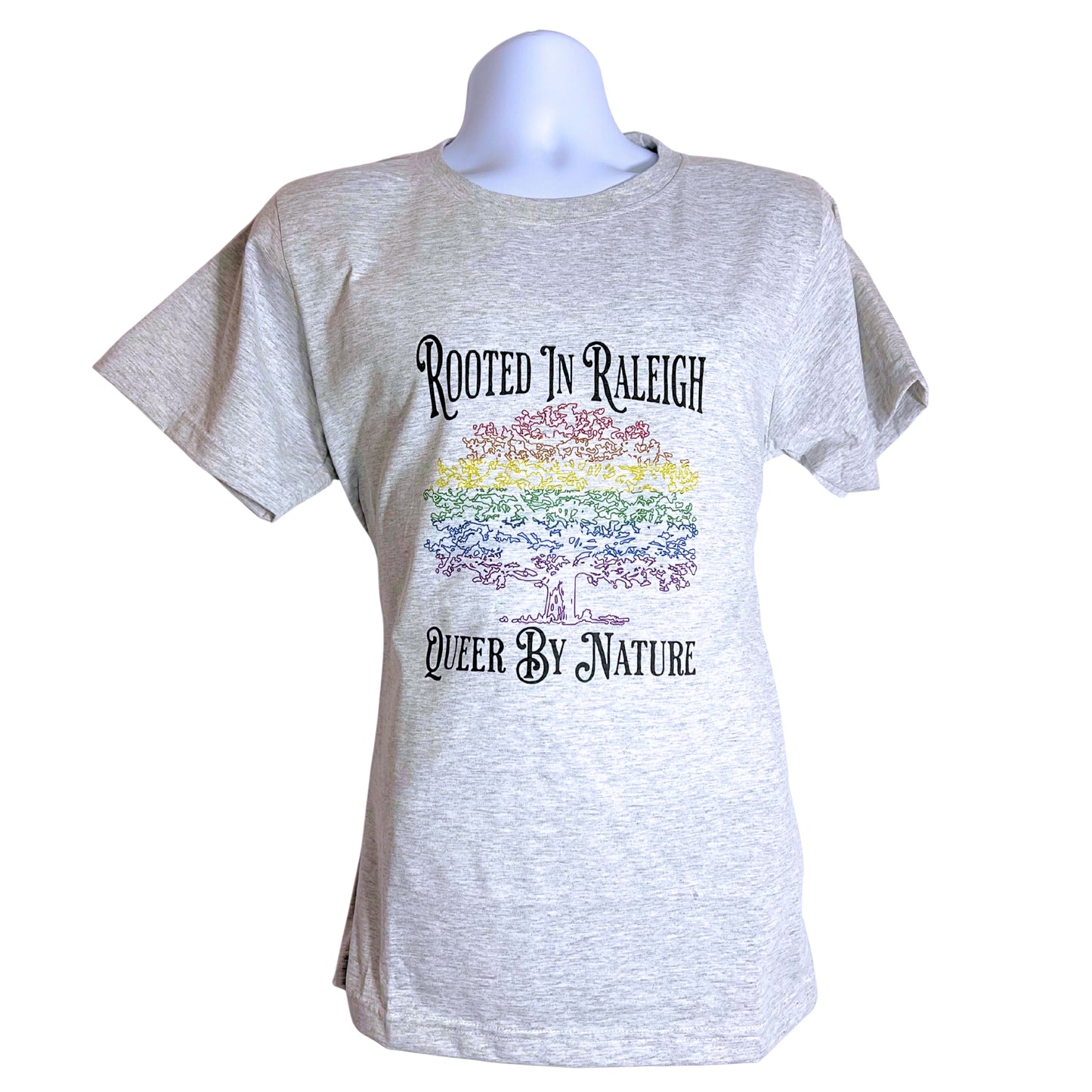 Light gray unisex T-shirt with rainbow tree design and text “Rooted in Raleigh – Queer by Nature,” on plain white background.