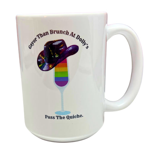 White 15 oz ceramic mug with rainbow mimosa, sequin cowboy hat, and text reading “Gayer Than Brunch at Dolly’s – Pass the Quiche,” on white background.