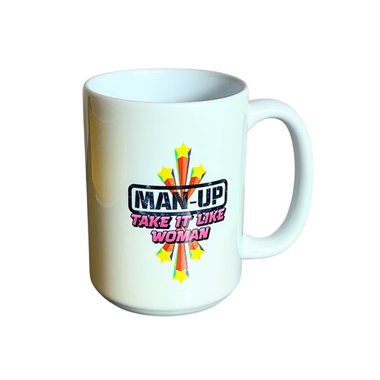White 15 oz ceramic mug with retro starburst design and text “Man Up – Take It Like a Woman,” on plain white background.