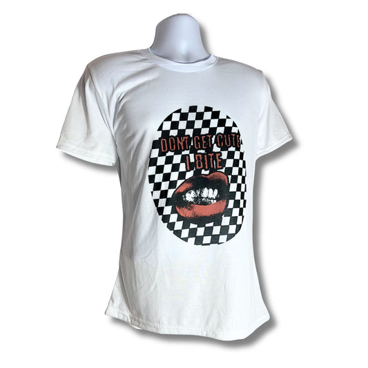 White T-shirt with “Don’t Get Cute, I Bite” design featuring red lips biting against a black-and-white checkerboard pattern, displayed on mannequin, white background.