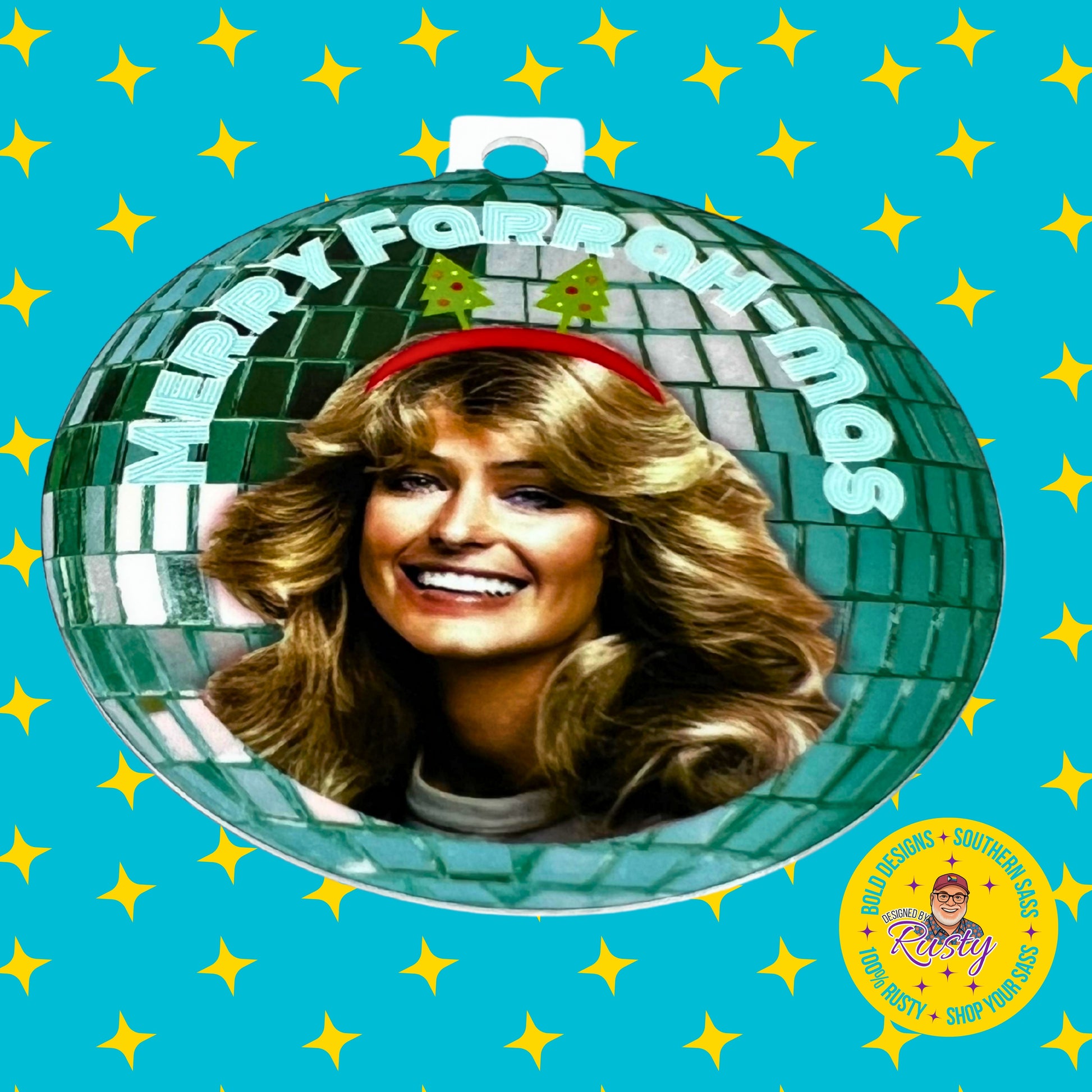 ‘Merry Farrah-mas’ ornament with Farrah Fawcett and green disco-ball design, displayed on turquoise Designed by Rusty background with yellow stars.