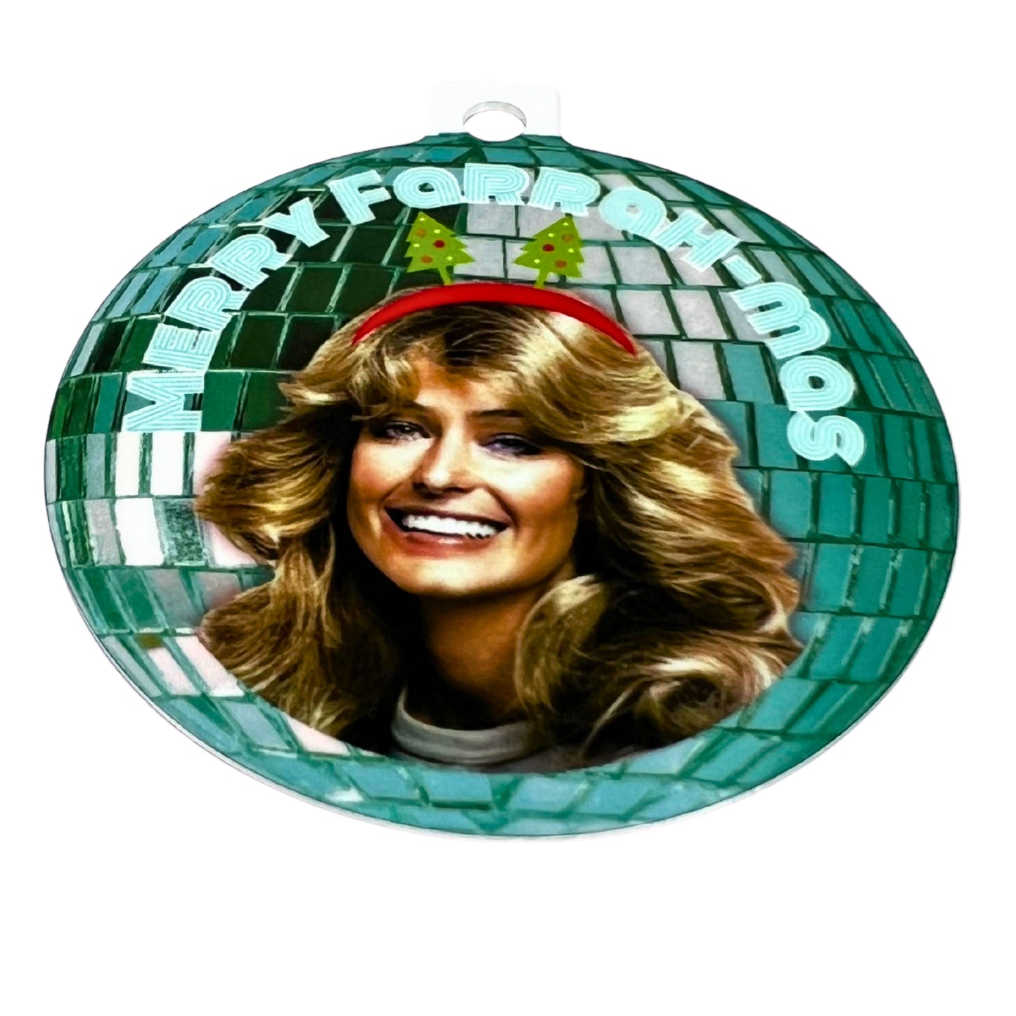 Round Christmas ornament with a green disco-ball design featuring Farrah Fawcett and the text ‘Merry Farrah-mas,’ printed on white background with red ribbon.