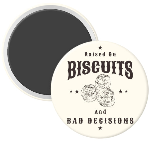 Round magnet with text 'Raised on Biscuits and Bad Decisions' and biscuit graphics on a white background