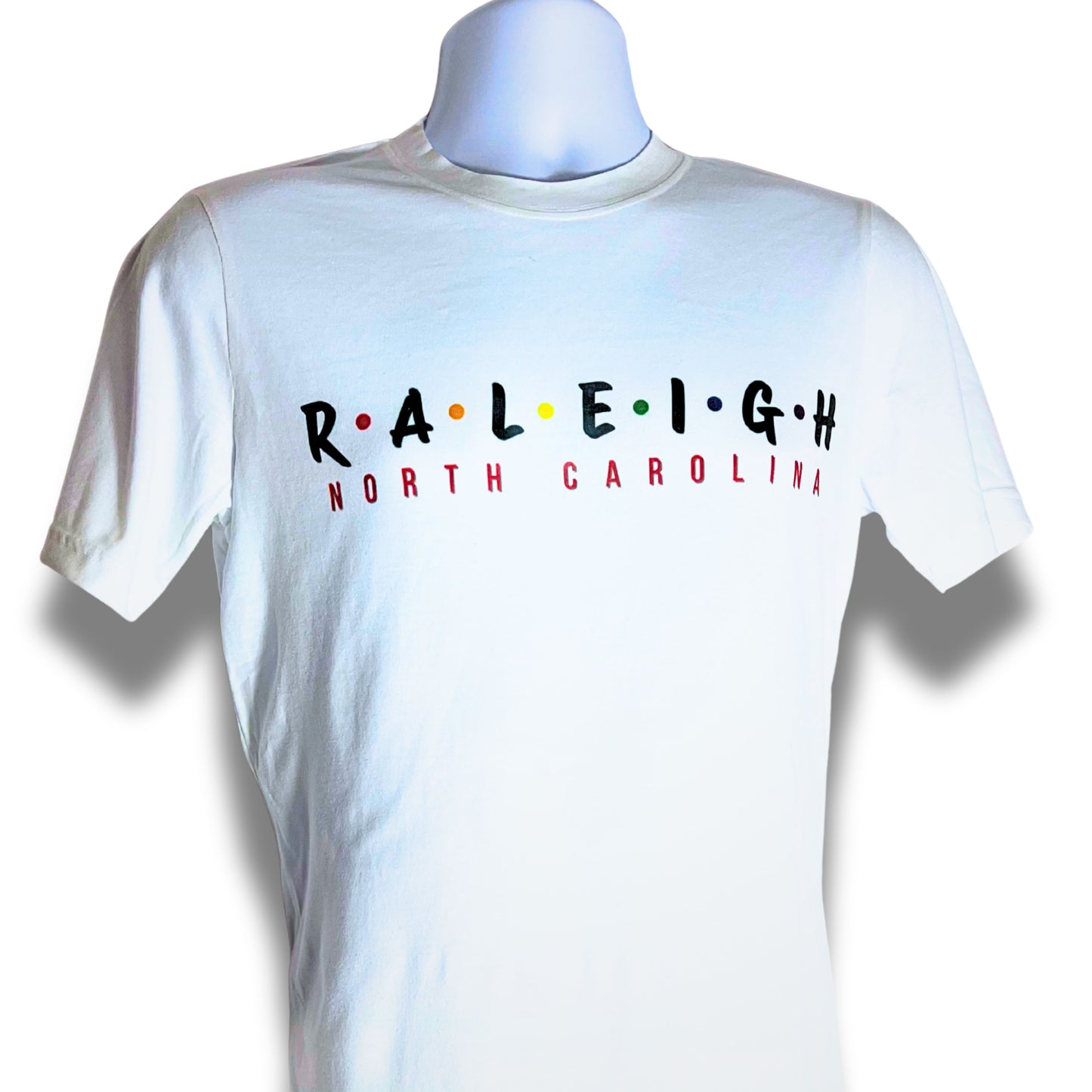 White t-shirt with 'RALEIGH NORTH CAROLINA' text on a mannequin against a white background