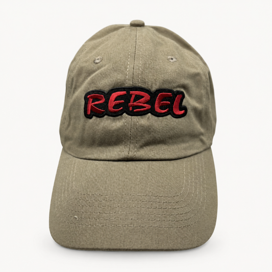 A baseball cap in a washed khaki or olive-tan color, featuring the word 'REBEL' embroidered across the front in red with a black outline.