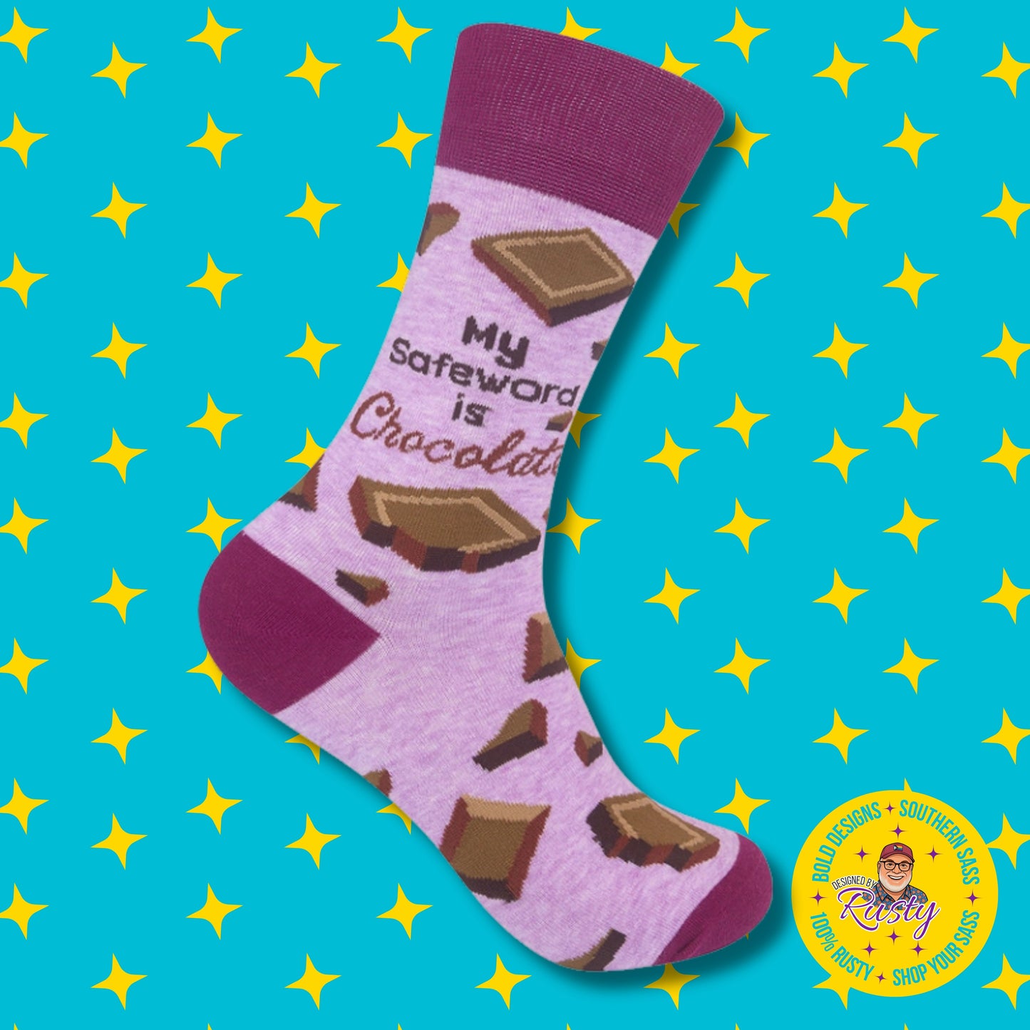 Pink crew socks with chocolate bar pattern and “My safeword is chocolate” text on turquoise background with yellow stars and Designed by Rusty logo.
