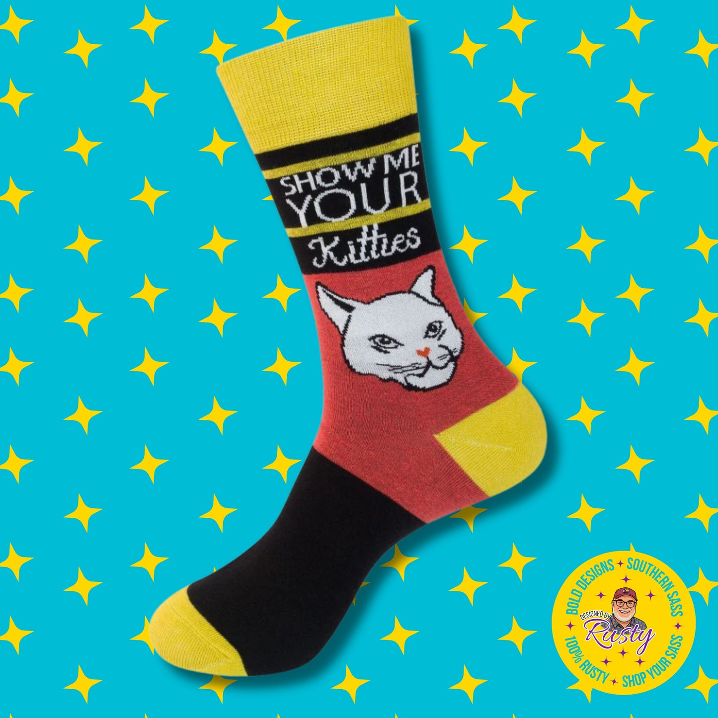 Colorblock novelty crew socks with cat graphic and “Show me your kitties” text, on turquoise background with yellow stars and Designed by Rusty logo.
