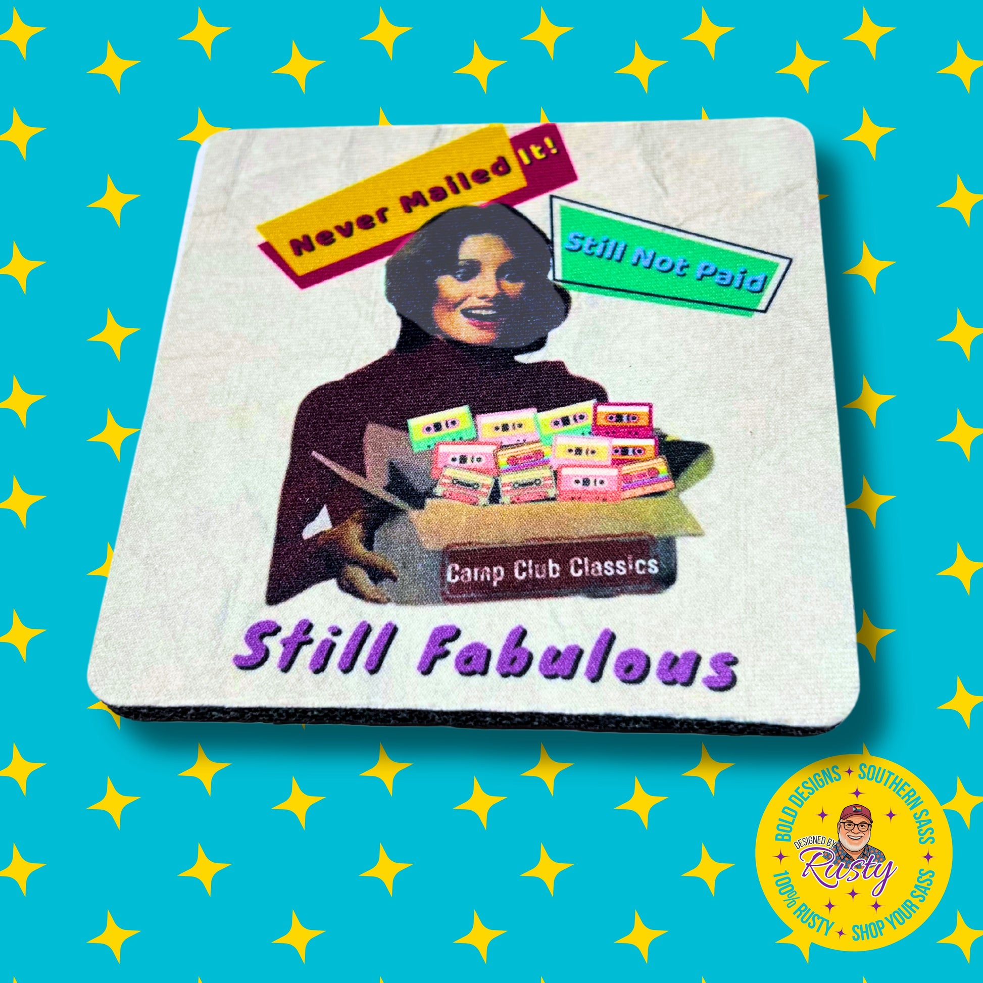 White 4x4 coaster with rainbow “Still Fabulous” design, on turquoise background with yellow stars and Designed by Rusty logo.