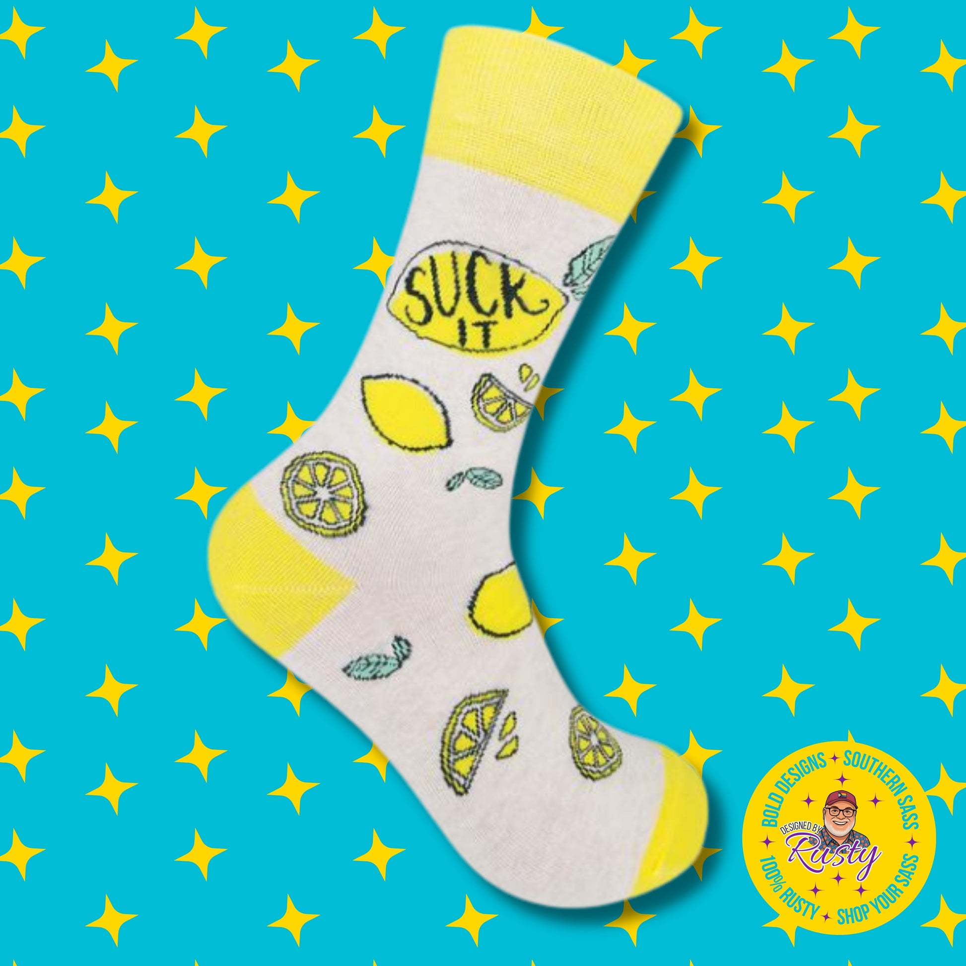 Gray and yellow crew socks with lemon illustrations and “Suck it” text on turquoise background with yellow stars and Designed by Rusty logo.
