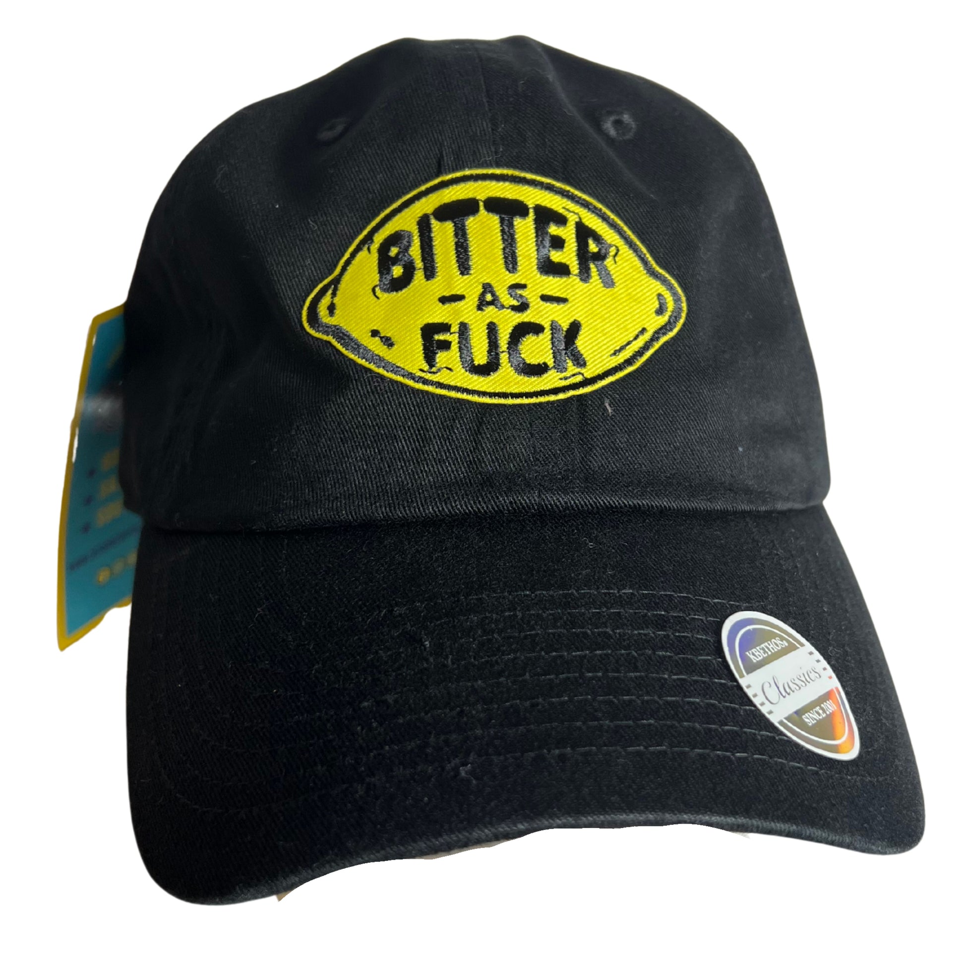 Black embroidered patch hat with yellow lemon design and bold text reading “Bitter As Fuck,” displayed on a pure white background.