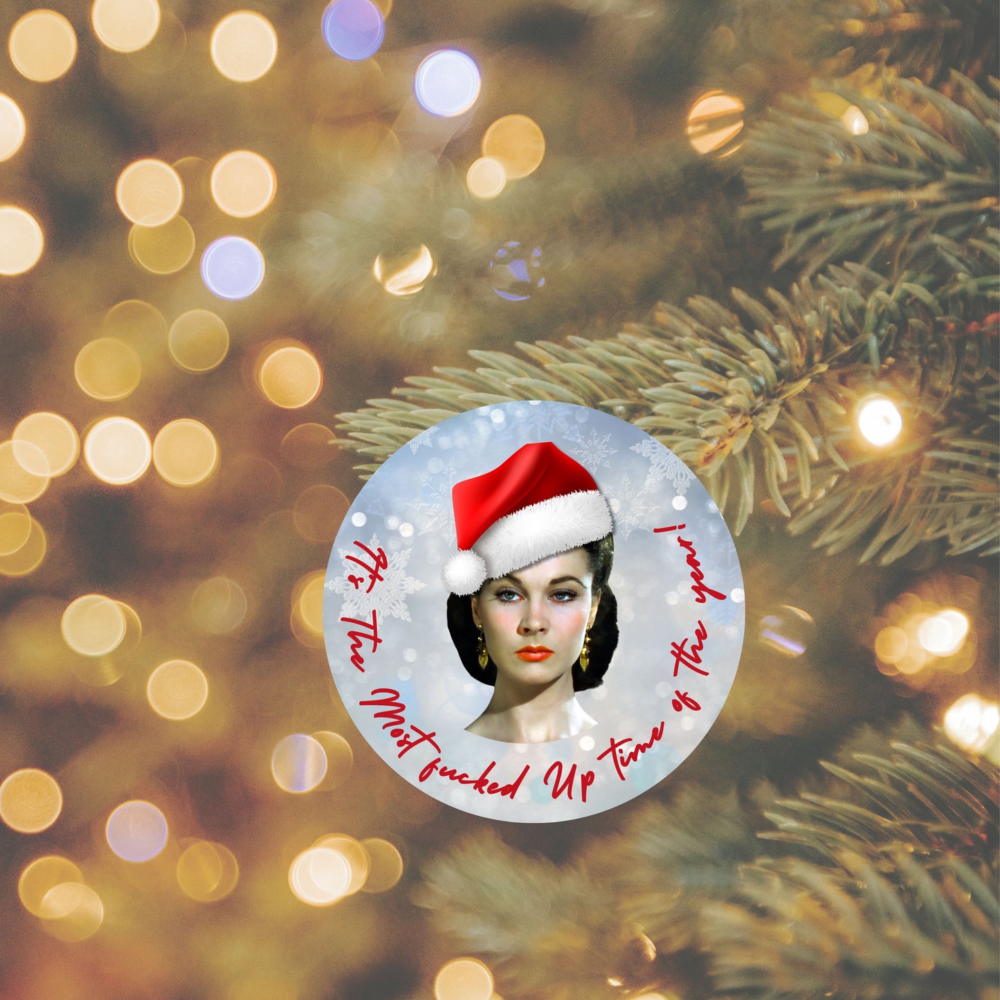 Vintage-style Christmas ornament featuring a woman in a Santa hat and bold red script text, hanging on a Christmas tree with warm holiday lights.”